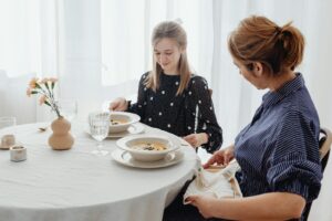 Women Sitting by a Dining Table